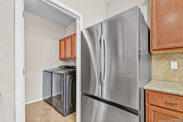 a metallic refrigerator freezer sitting in a kitchen