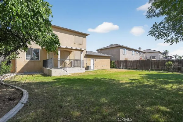 a view of a house with a yard and sitting area