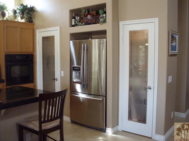 49364 Wayne Street Indio, CA 92201 - Photo 11 of 25 a kitchen with a refrigerator and wooden floor