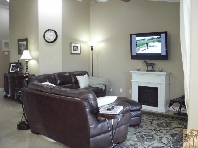 49364 Wayne Street Indio, CA 92201 - Photo 13 of 25 a living room with furniture a fireplace and wall painting