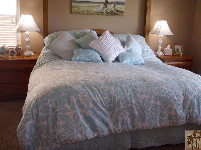 49364 Wayne Street Indio, CA 92201 - Photo 15 of 25 a large bed sitting in a bedroom next to a lamp