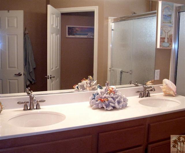 49364 Wayne Street Indio, CA 92201 - Photo 16 of 25 a bathroom with double vanity sinks and a mirror