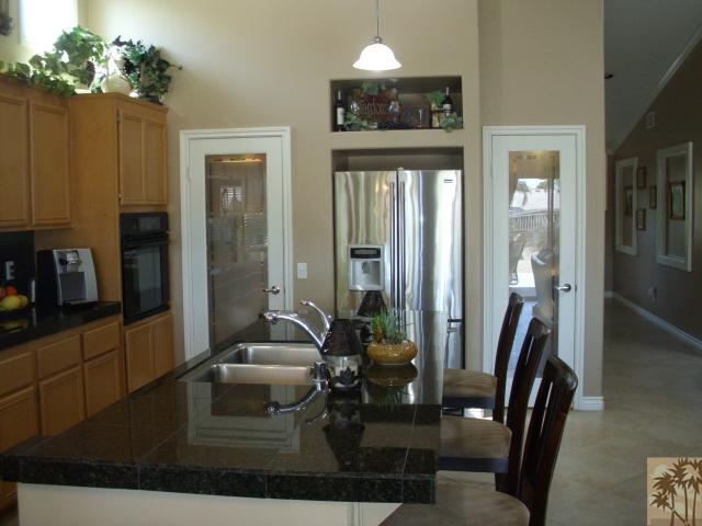 49364 Wayne Street Indio, CA 92201 - Photo 9 of 25 a living room with furniture and a chandelier