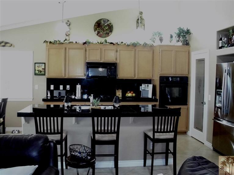 49364 Wayne Street Indio, CA 92201 - Photo 10 of 25 a kitchen with a dining table and chairs