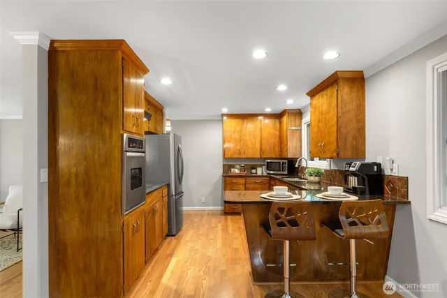 a kitchen with stainless steel appliances a sink stove and refrigerator