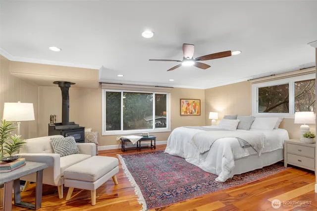 a bedroom with a large bed and a large window