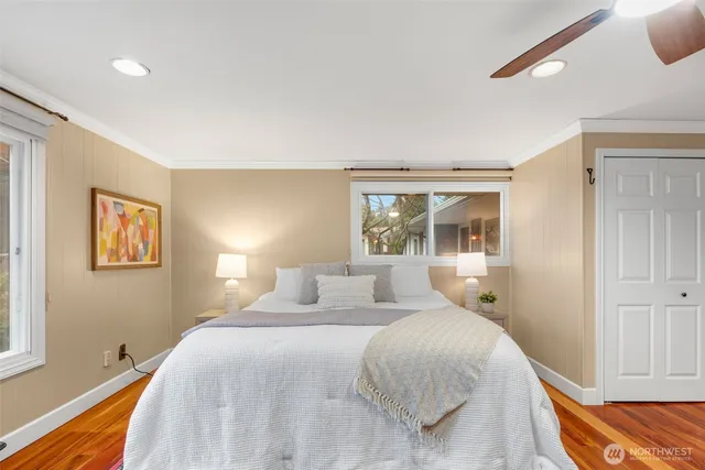 a bedroom with a large bed and a window