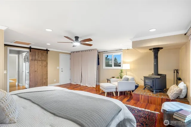 a bedroom with furniture and a large window