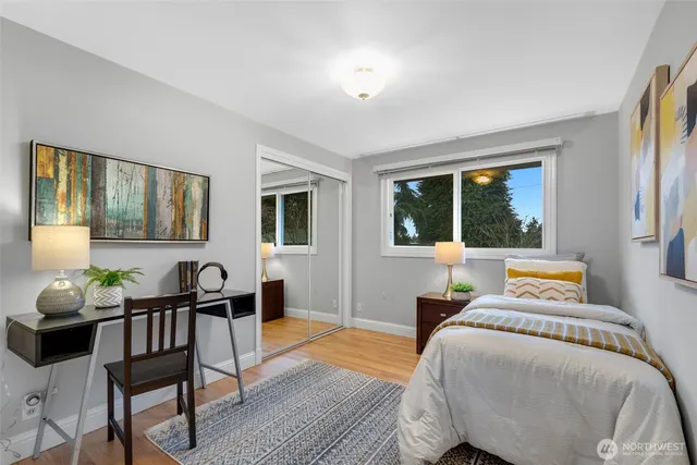 a bedroom with furniture and a large window