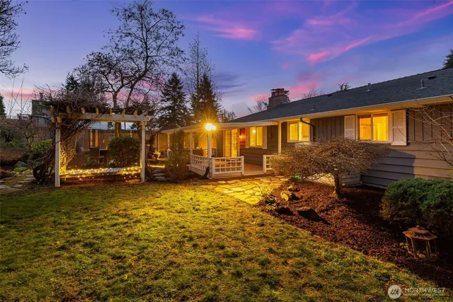 a backyard of a house with table and chairs