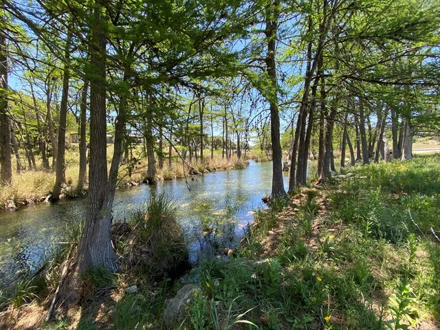 a view of lake with a house in background