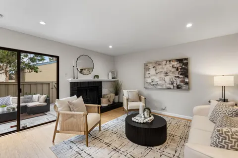 a living room with furniture a rug and a large window