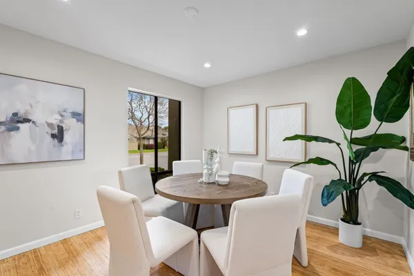 a view of a dining room with furniture window and wooden floor