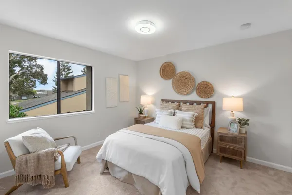 a bedroom with a bed and window