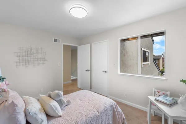 a bedroom with a bed and a window