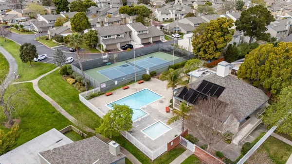 an aerial view of a house with a swimming pool