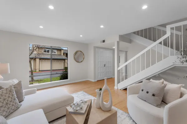 a living room with furniture and a wooden floor