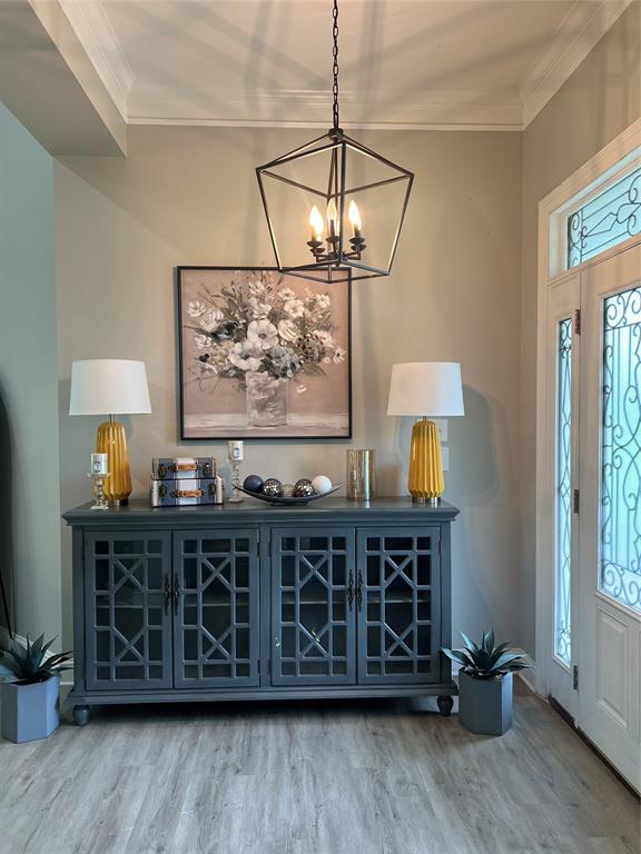 5270 Quad J Road Shreveport, LA 71107 - Photo 2 of 18 a living room with wooden furniture a rug and a chandelier