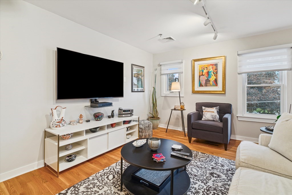12 Benton Street, Unit 4 Stoneham, MA 02180 - Photo 12 of 35 a living room with furniture and a flat screen tv