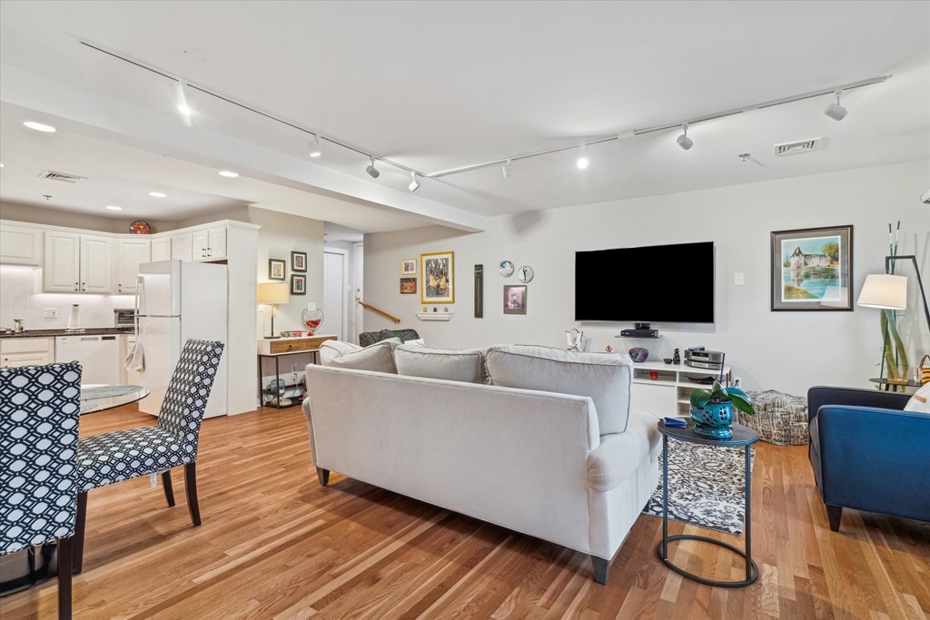 12 Benton Street, Unit 4 Stoneham, MA 02180 - Photo 13 of 35 a living room with furniture and a flat screen tv