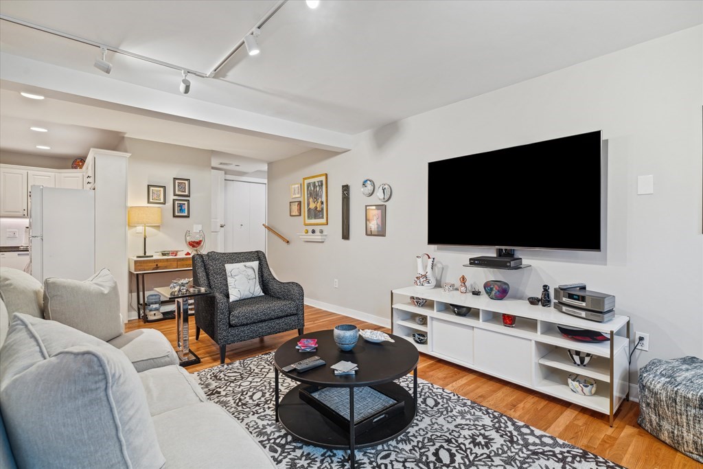 12 Benton Street, Unit 4 Stoneham, MA 02180 - Photo 14 of 35 a living room with furniture and a flat screen tv