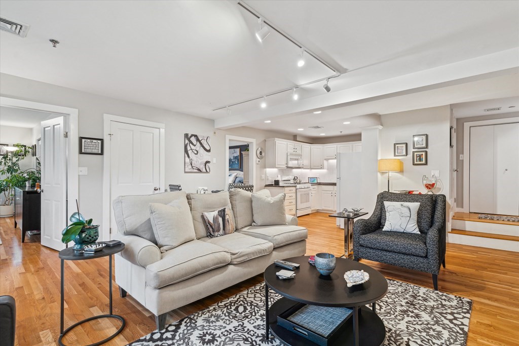 12 Benton Street, Unit 4 Stoneham, MA 02180 - Photo 15 of 35 a living room with furniture and wooden floor