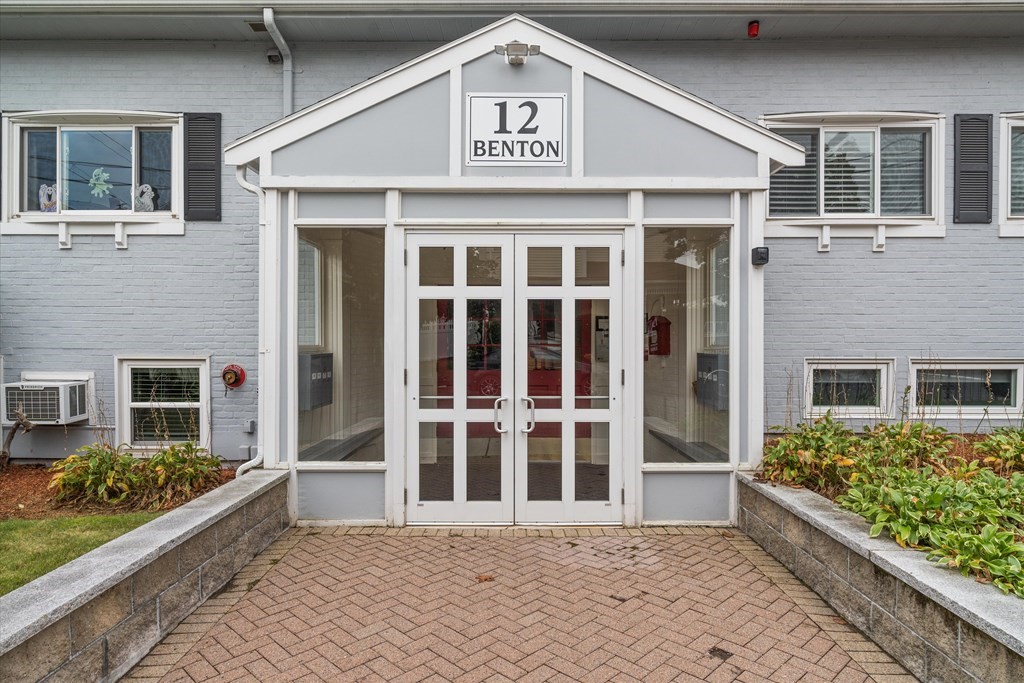 12 Benton Street, Unit 4 Stoneham, MA 02180 - Photo 2 of 35 a front view of a building with a garden
