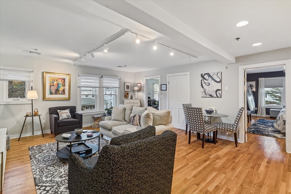12 Benton Street, Unit 4 Stoneham, MA 02180 - Photo 21 of 35 a living room with furniture and wooden floor