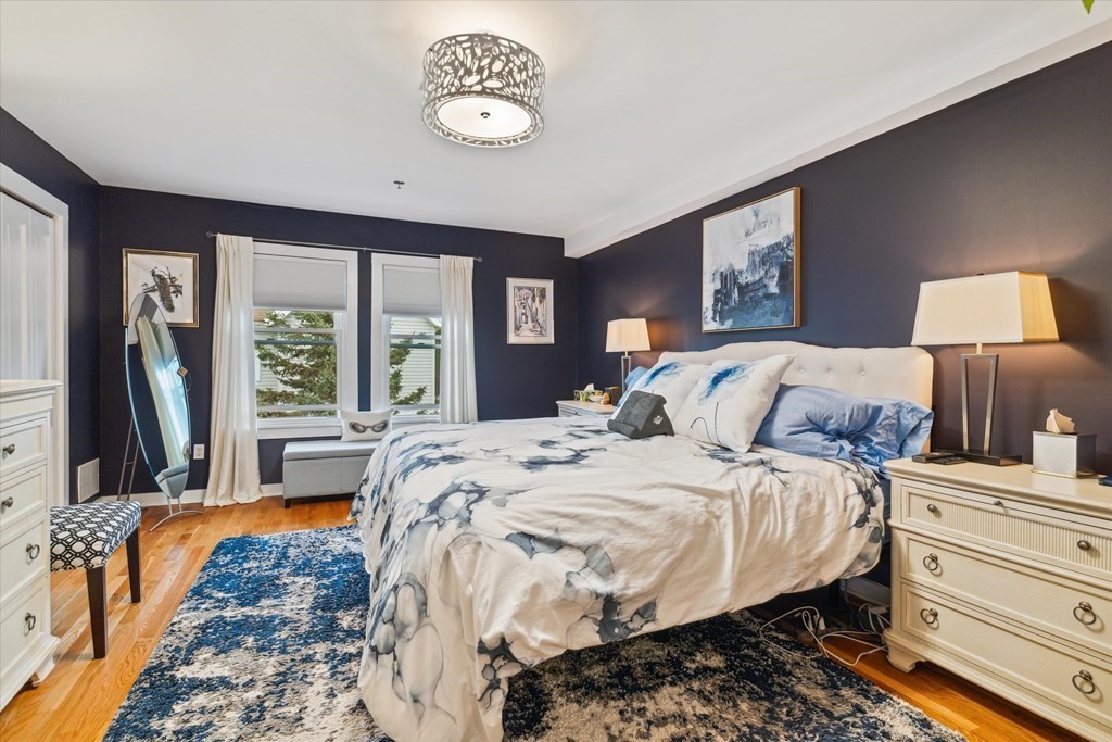 12 Benton Street, Unit 4 Stoneham, MA 02180 - Photo 23 of 35 a bed sitting in a bedroom next to a window