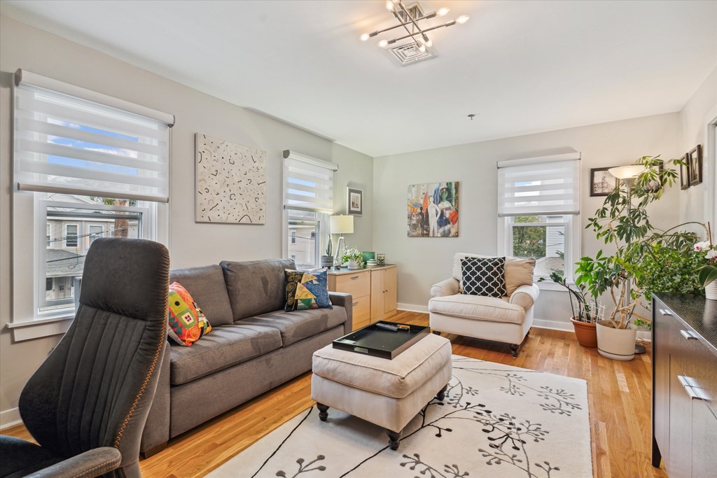 12 Benton Street, Unit 4 Stoneham, MA 02180 - Photo 25 of 35 a living room with furniture and a potted plant
