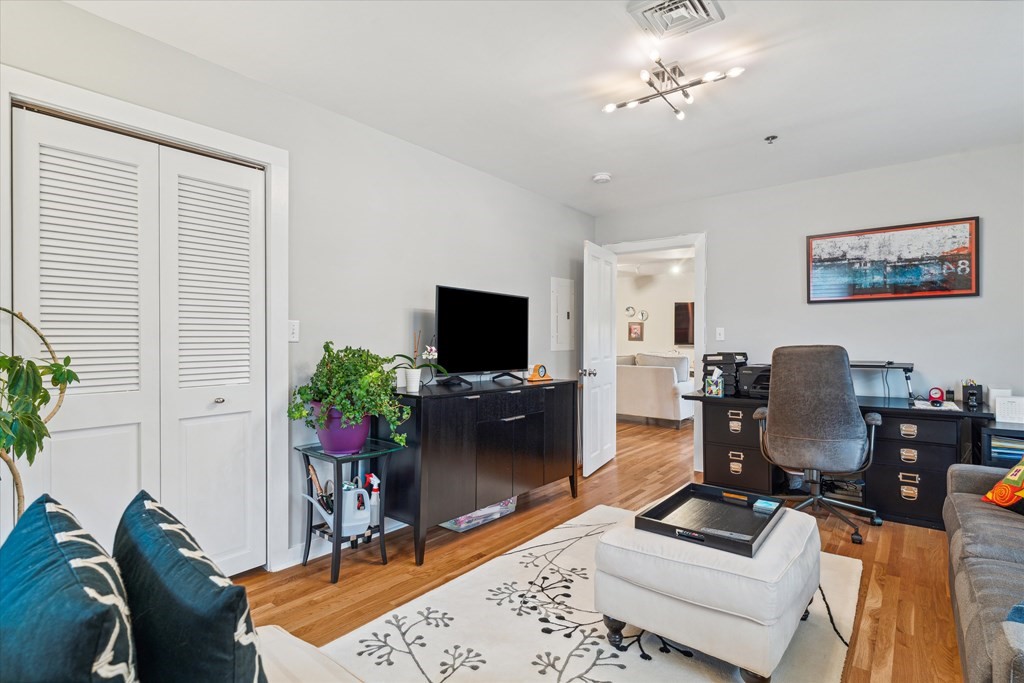 12 Benton Street, Unit 4 Stoneham, MA 02180 - Photo 26 of 35 a living room with furniture a dining table and a potted plant