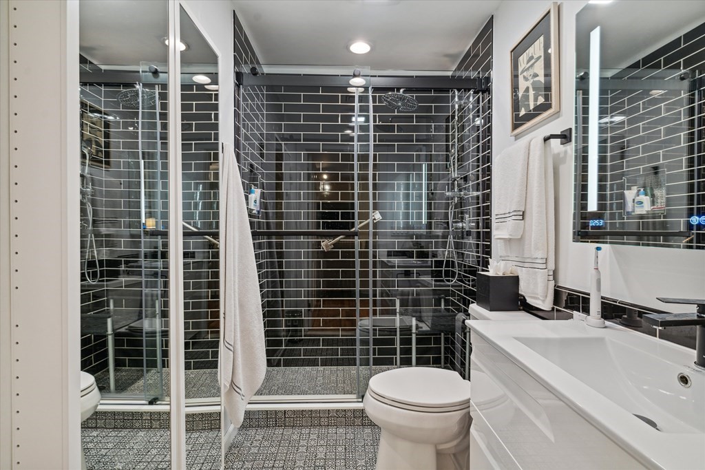 12 Benton Street, Unit 4 Stoneham, MA 02180 - Photo 28 of 35 a bathroom with a shower toilet and sink