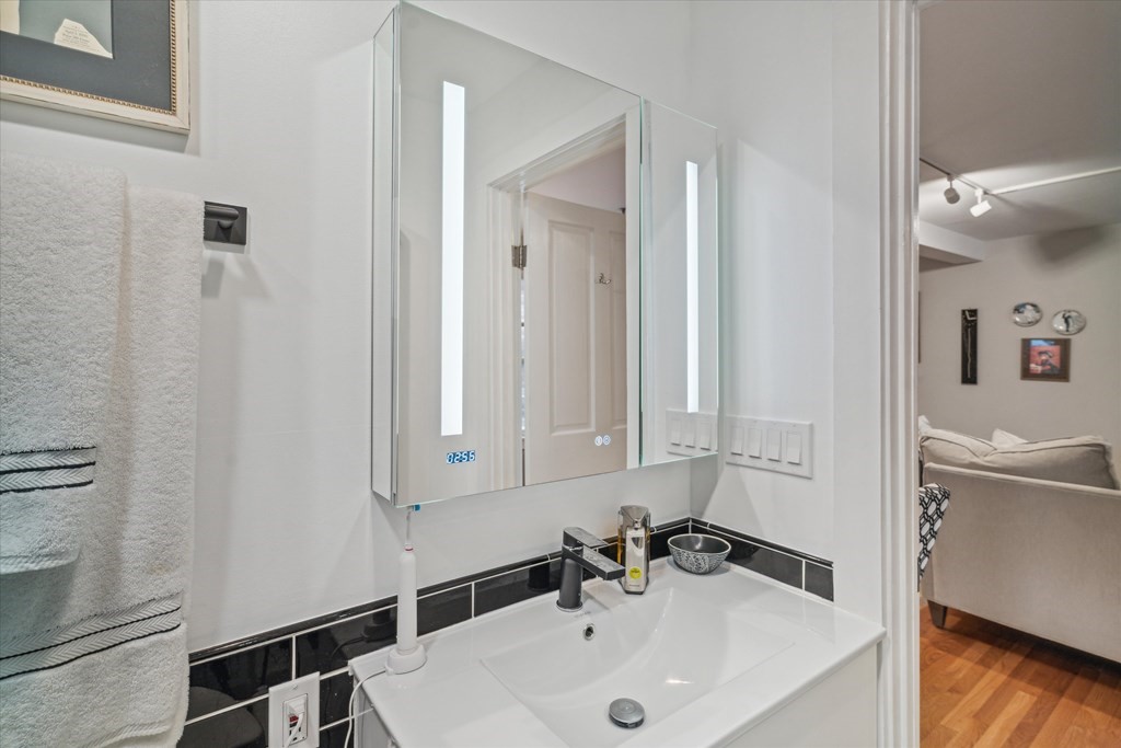 12 Benton Street, Unit 4 Stoneham, MA 02180 - Photo 29 of 35 a bathroom with a sink and a mirror