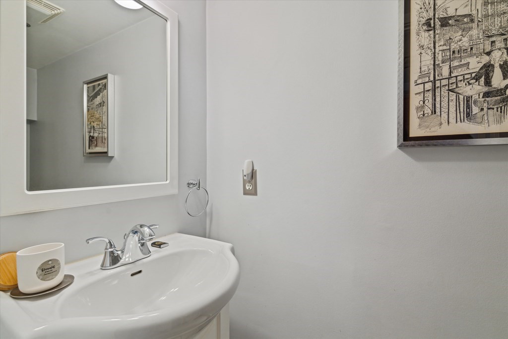 12 Benton Street, Unit 4 Stoneham, MA 02180 - Photo 30 of 35 a bathroom with a sink and a mirror