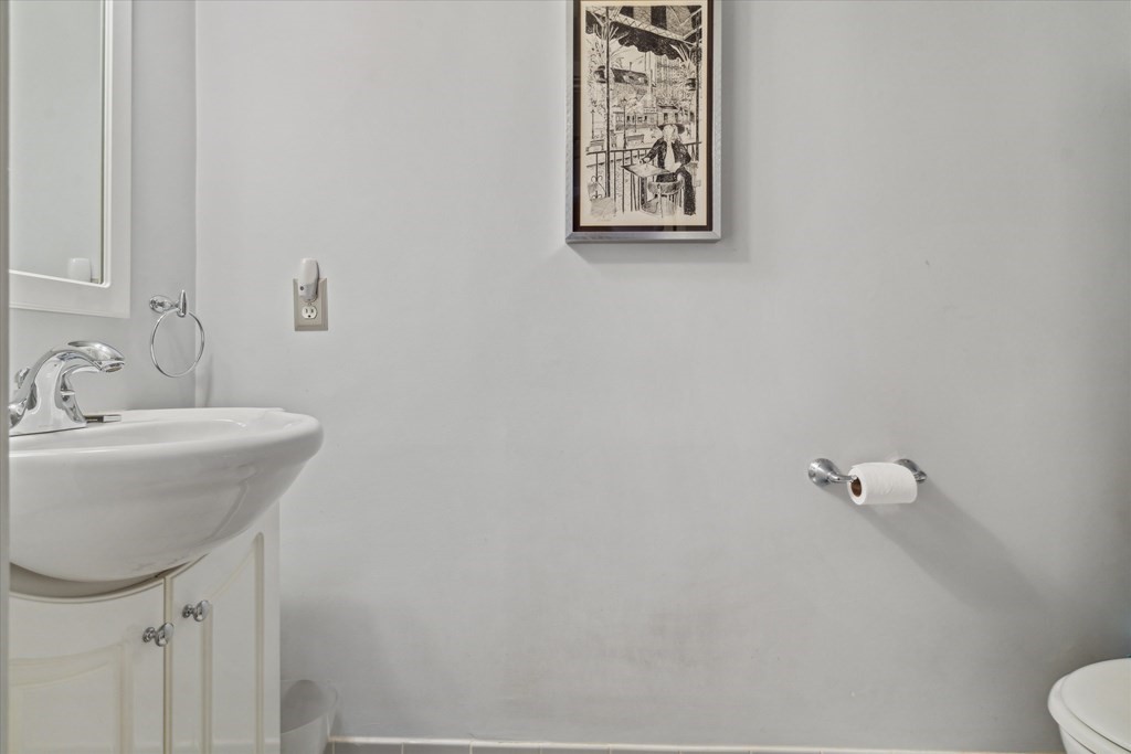 12 Benton Street, Unit 4 Stoneham, MA 02180 - Photo 31 of 35 a bathroom with a sink mirror and toilet