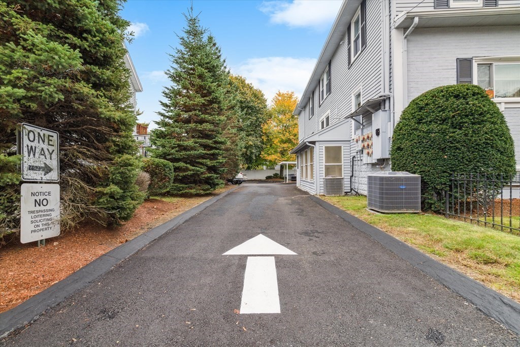 12 Benton Street, Unit 4 Stoneham, MA 02180 - Photo 33 of 35 a backyard of a house with a yard and garage