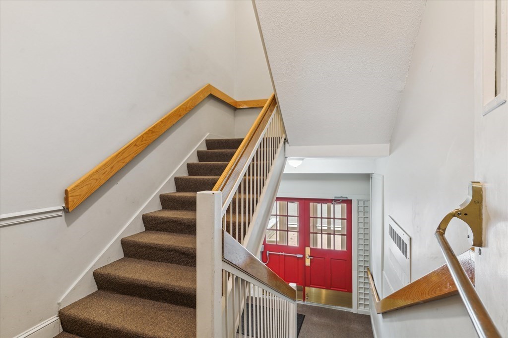 12 Benton Street, Unit 4 Stoneham, MA 02180 - Photo 4 of 35 a view of staircase with white walls