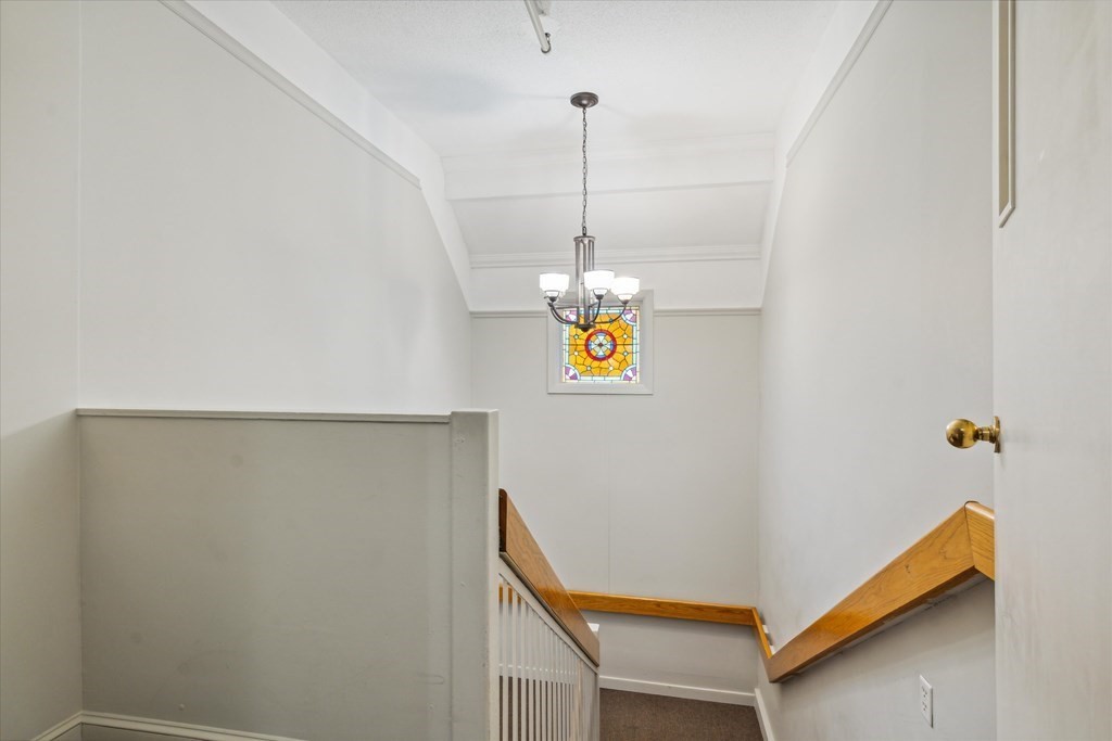 12 Benton Street, Unit 4 Stoneham, MA 02180 - Photo 5 of 35 a view of a hallway with painted walls