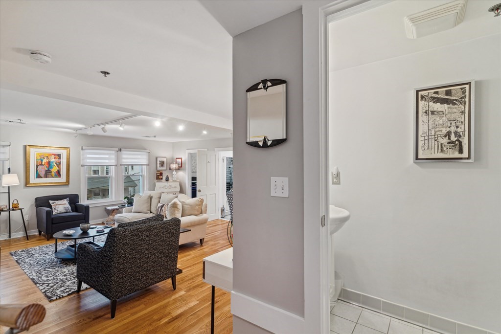 12 Benton Street, Unit 4 Stoneham, MA 02180 - Photo 8 of 35 a living room with furniture and wooden floor