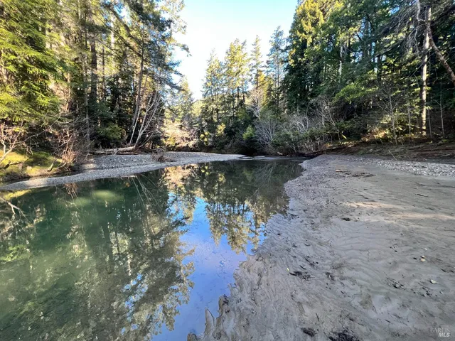 a view of a lake with trees