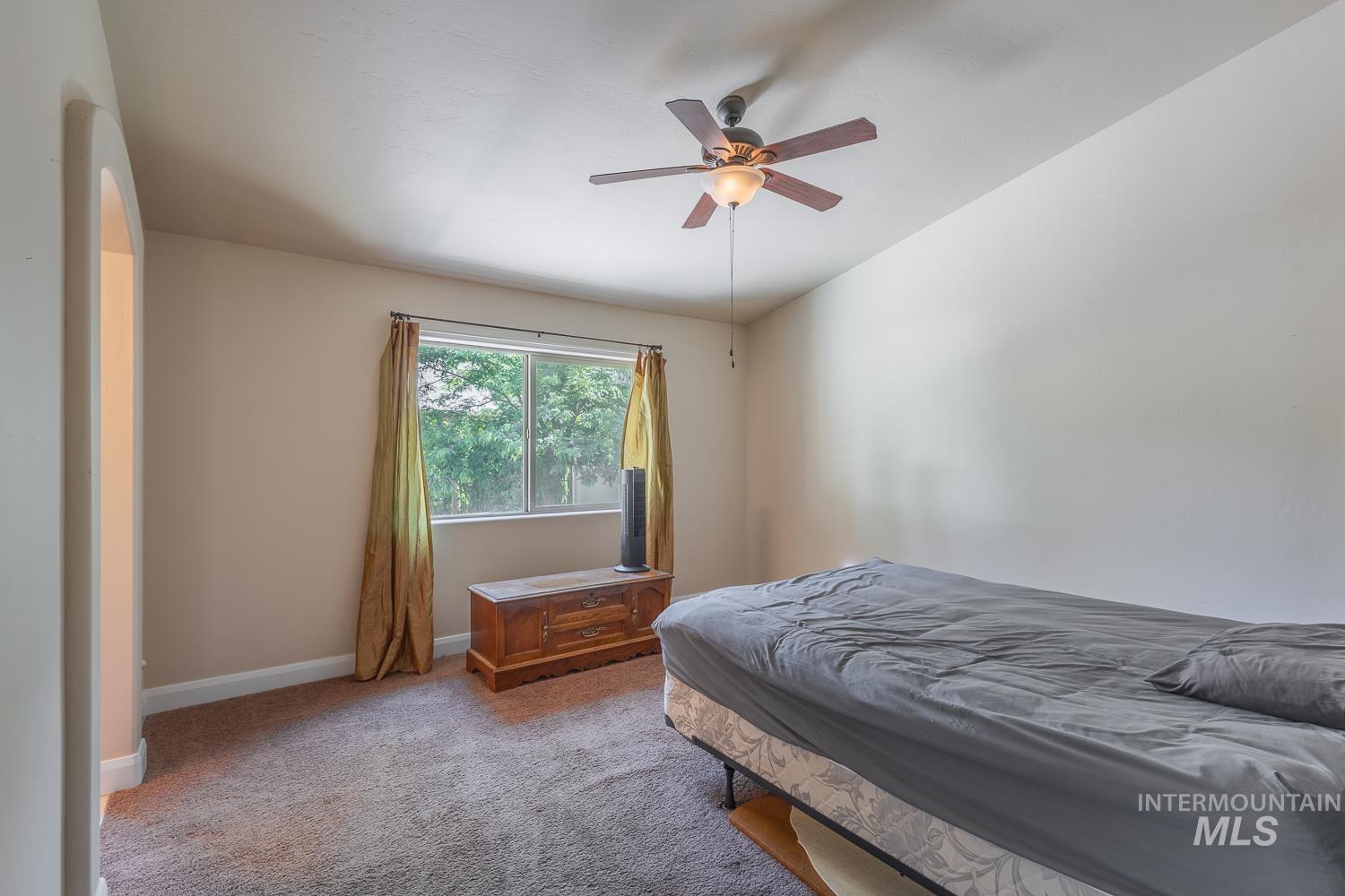1186 East Observation Street Meridian, ID 83642 - Photo 21 of 33 Carpeted room featuring a window with natural light, a ceiling fan with integrated lighting, and neutral wall tones