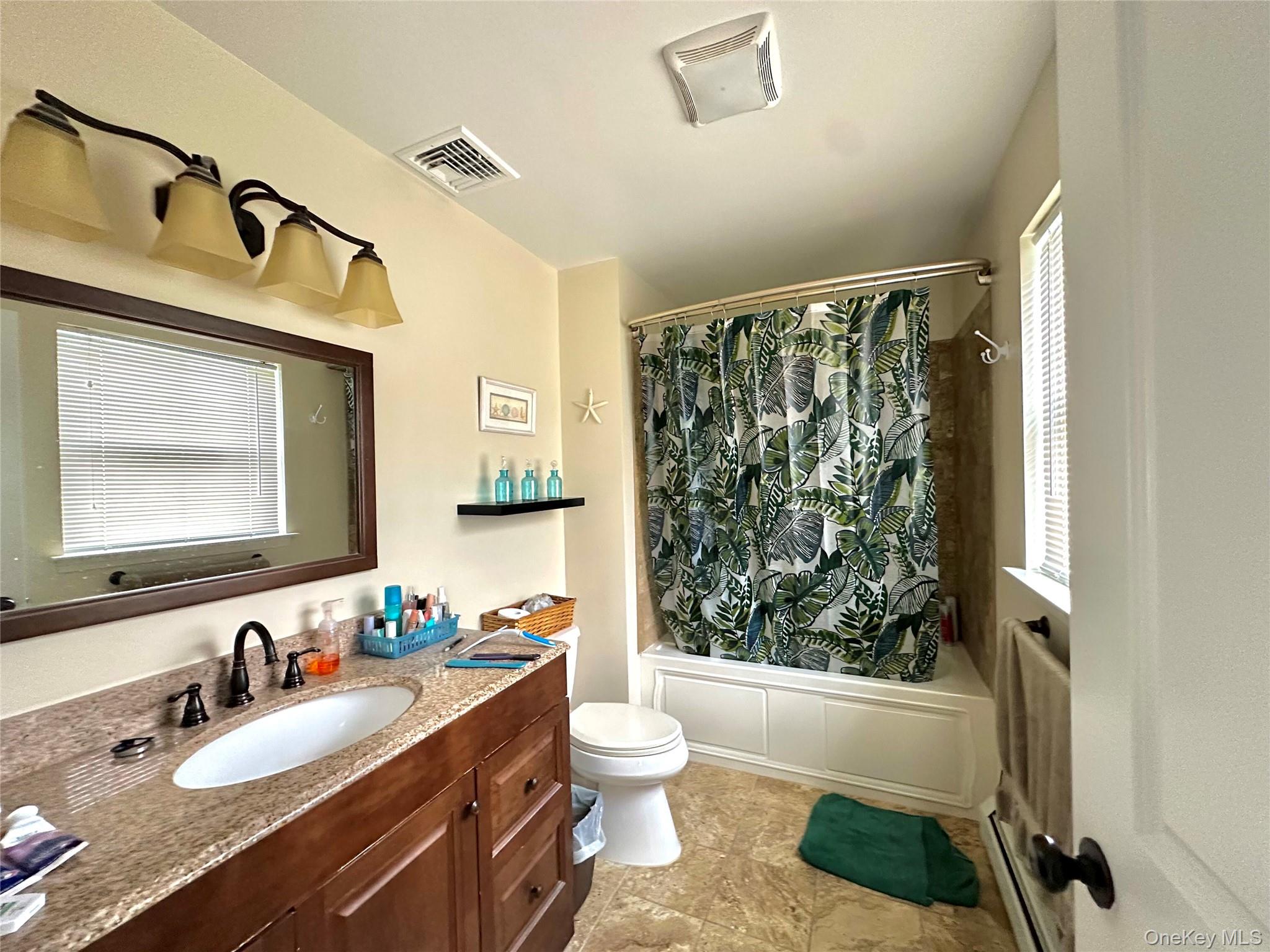 1091 Ridgebury Road New Hampton, NY 10958 - Photo 18 of 27 a bathroom with a granite countertop sink toilet a mirror a vanity and shower