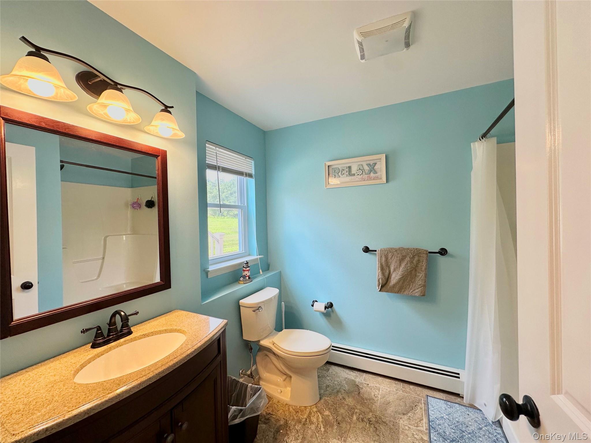 1091 Ridgebury Road New Hampton, NY 10958 - Photo 9 of 27 a bathroom with a granite countertop toilet sink and mirror