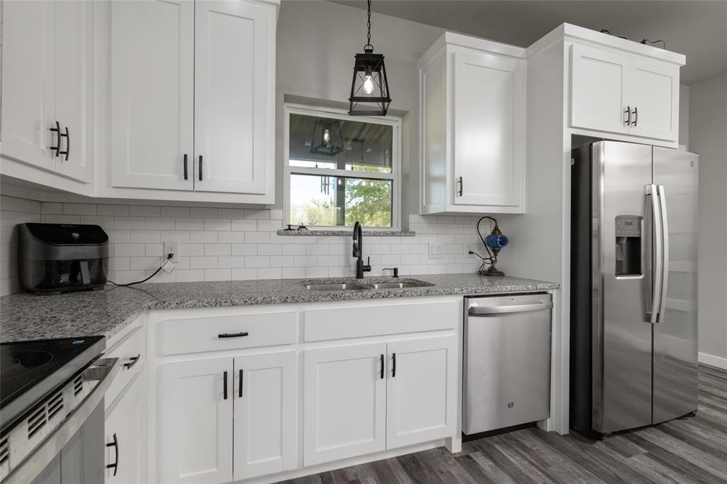 115 Valley Ridge Drive Bridgeport, TX 76426 - Photo 14 of 35 a kitchen with appliances cabinets and a sink