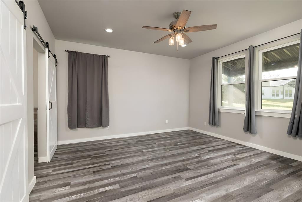 115 Valley Ridge Drive Bridgeport, TX 76426 - Photo 17 of 35 a view of an empty room with window and wooden floor