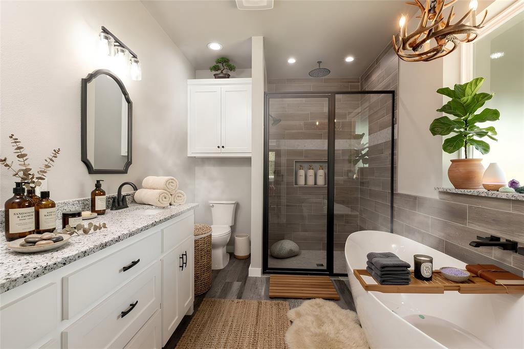 115 Valley Ridge Drive Bridgeport, TX 76426 - Photo 22 of 35 a bathroom with a granite countertop sink a mirror and shower