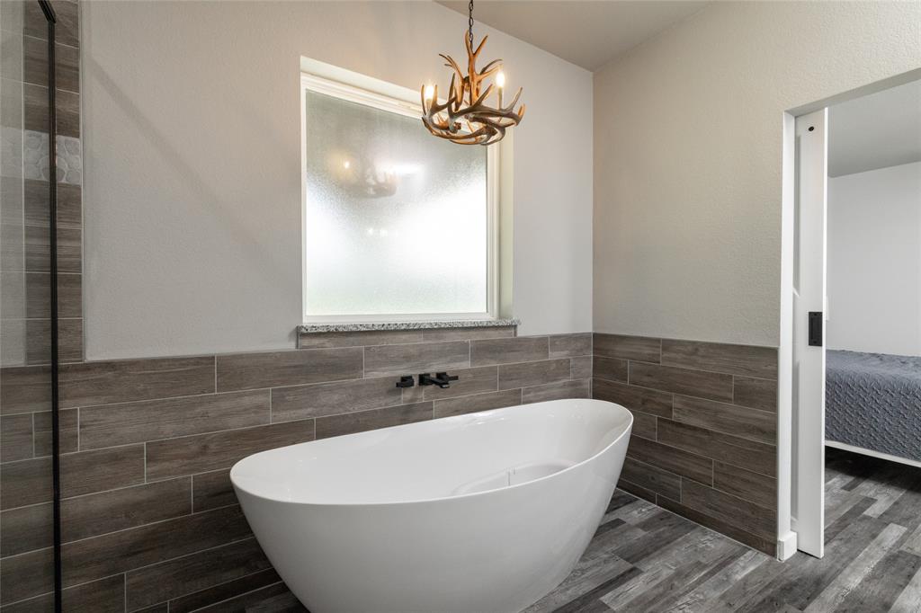 115 Valley Ridge Drive Bridgeport, TX 76426 - Photo 23 of 35 a white bath tub sitting in a bathroom