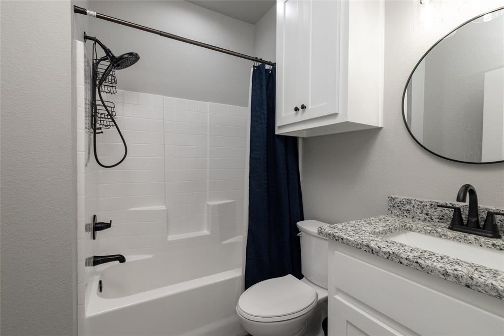 115 Valley Ridge Drive Bridgeport, TX 76426 - Photo 28 of 35 a bathroom with a granite countertop sink a toilet and shower