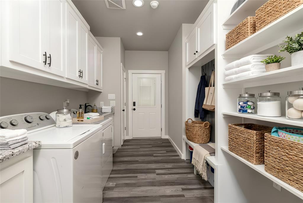 115 Valley Ridge Drive Bridgeport, TX 76426 - Photo 32 of 35 a hallway with white cabinets and washer
