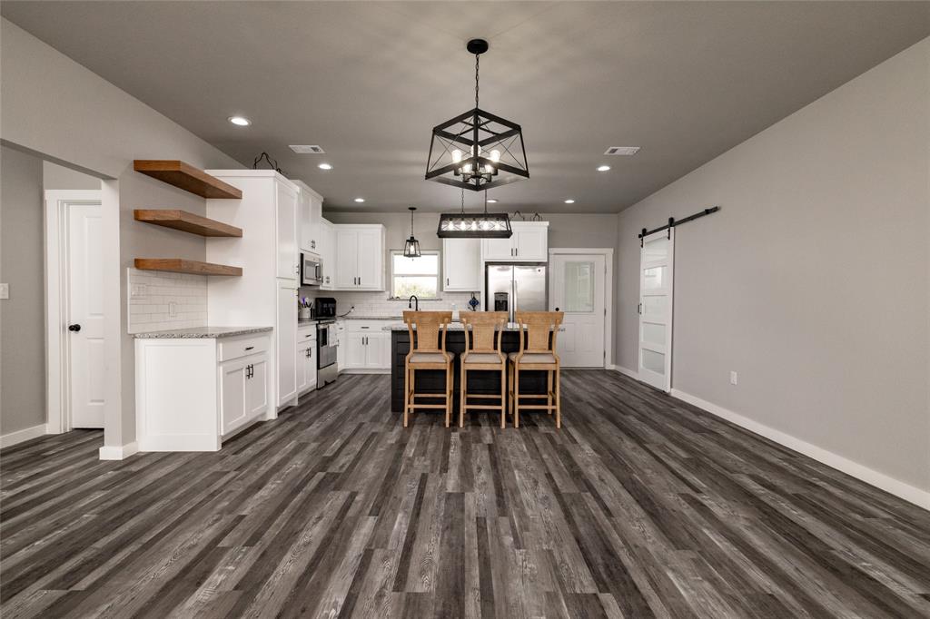 115 Valley Ridge Drive Bridgeport, TX 76426 - Photo 10 of 35 a view of a dining room with furniture window and wooden floor